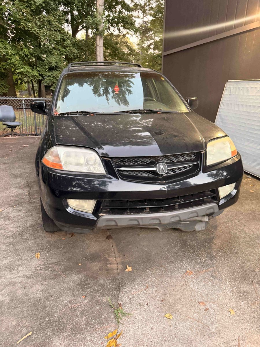 Black Acura MDX SUV we bought for cash